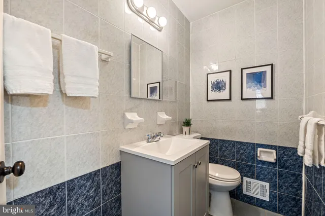 a bathroom with a sink toilet and mirror