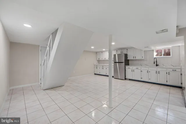 a view of a kitchen with white cabinets
