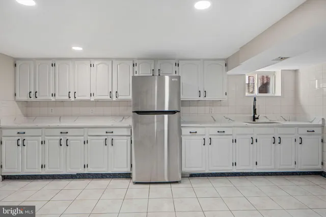 a kitchen with white cabinets