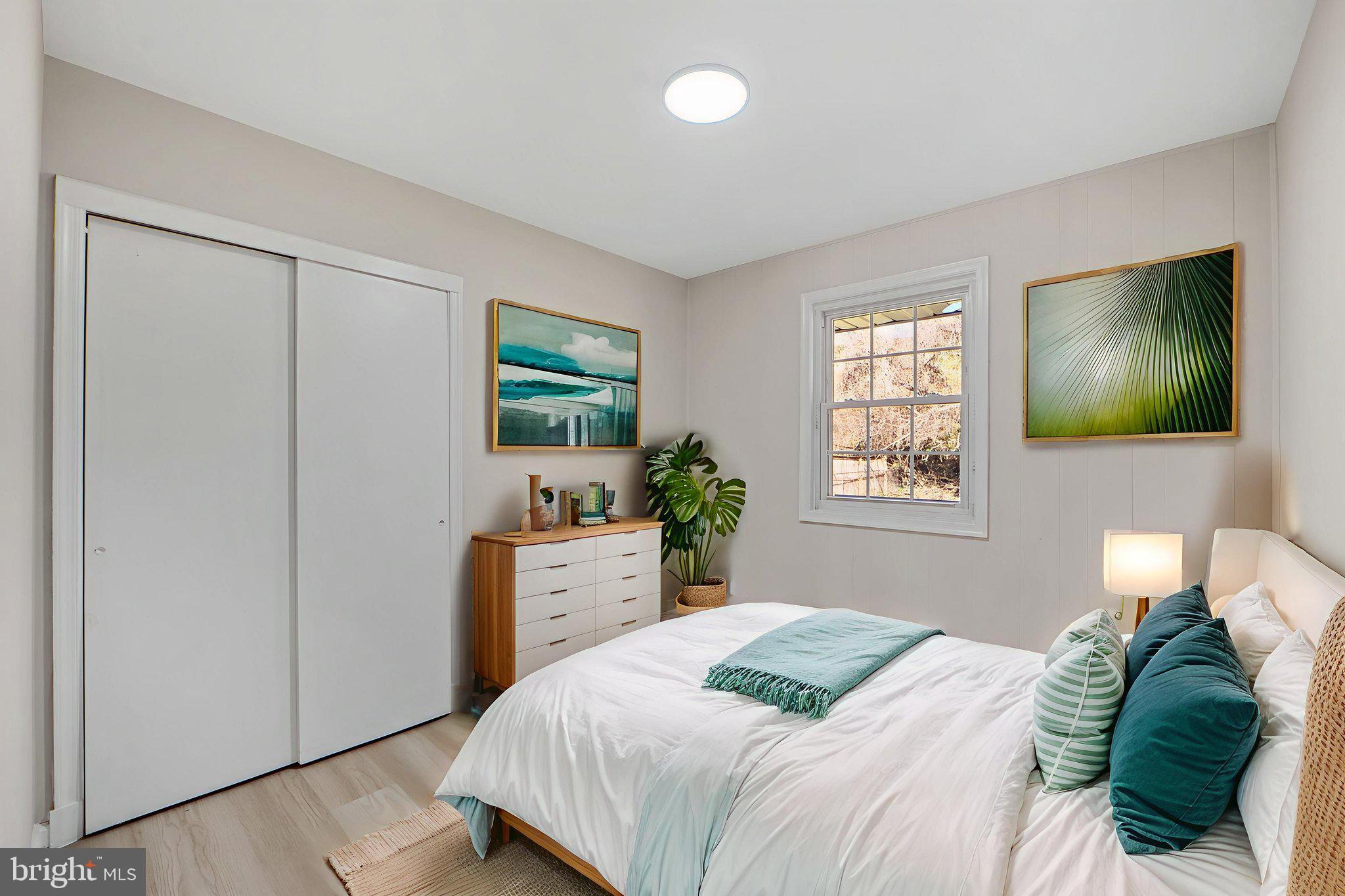 1513 Flora Lane Silver Spring, MD 20910 - Photo 27 of 50 a bedroom with a bed and a flat screen tv