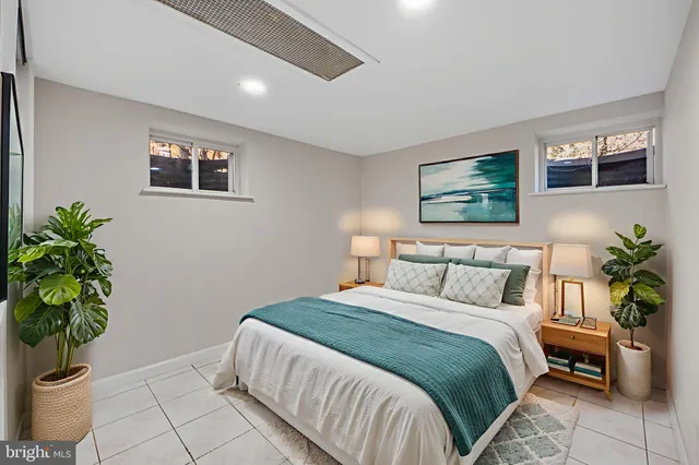 a bedroom with bed and a potted plant