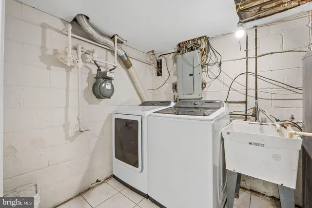 a utility room with a shower and mirror