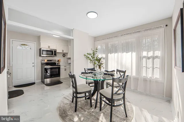 a view of a dining room with furniture and chandelier