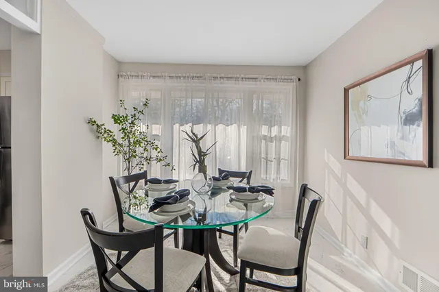 a view of a dining room with furniture and window