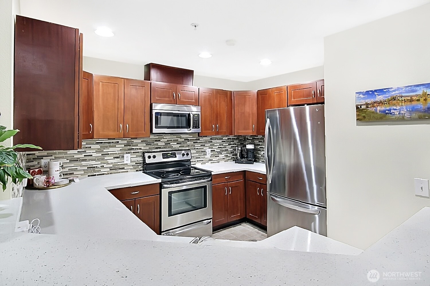 5921 South 234th Place Kent, WA 98032 - Photo 12 of 25 a kitchen with stainless steel appliances granite countertop a refrigerator sink and stove