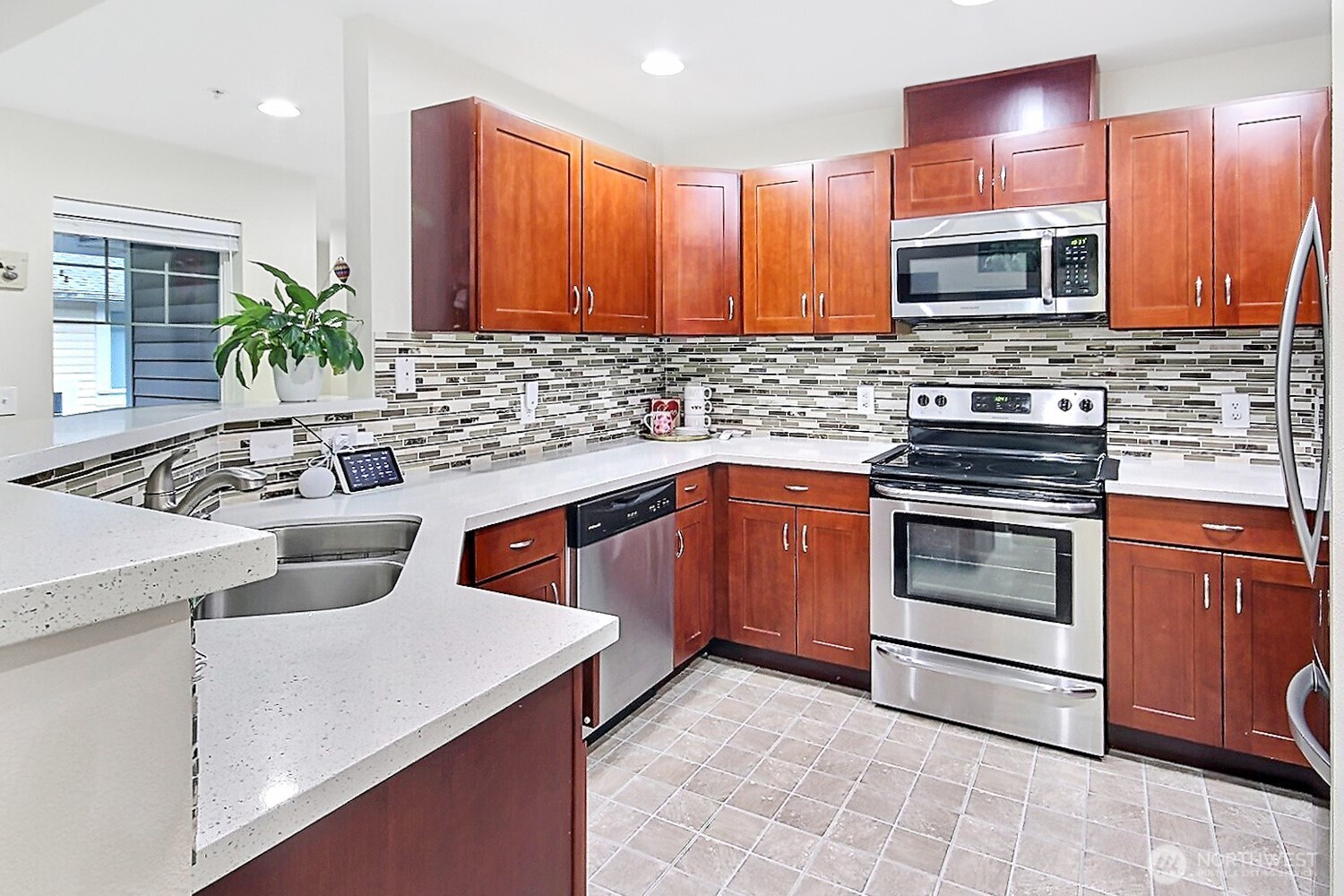 5921 South 234th Place Kent, WA 98032 - Photo 7 of 25 a kitchen with stainless steel appliances a stove microwave and sink