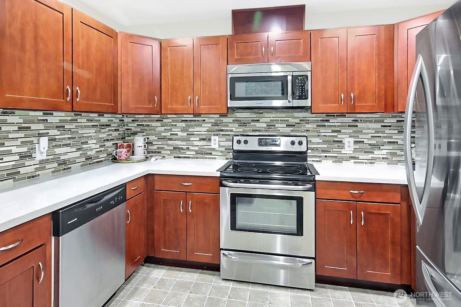 5921 South 234th Place Kent, WA 98032 - Photo 8 of 25 a kitchen with sink a microwave and cabinets