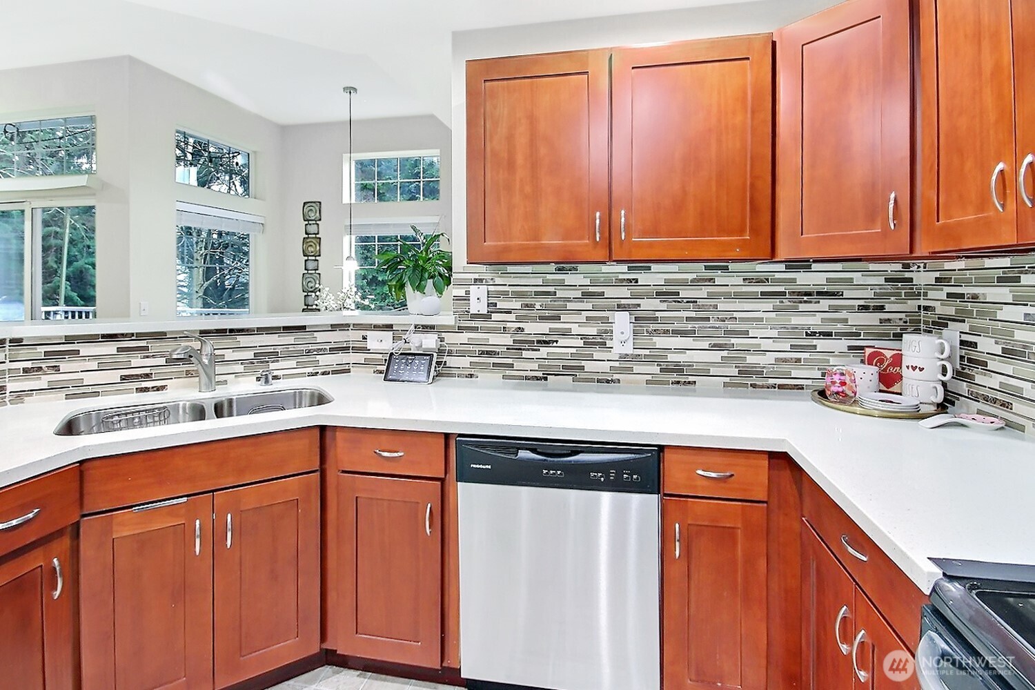 5921 South 234th Place Kent, WA 98032 - Photo 10 of 25 a kitchen with stainless steel appliances granite countertop cabinets sink and window