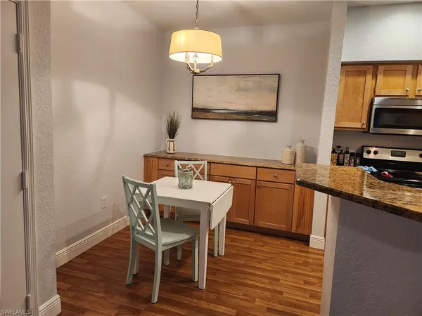 a view of a dining room with furniture wooden floor and chandelier
