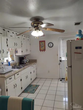 a kitchen with granite countertop a sink a stove and cabinets