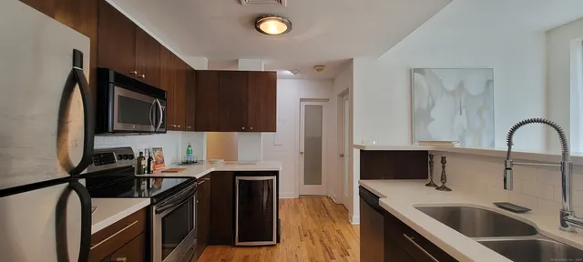 a kitchen with a sink appliances and cabinets
