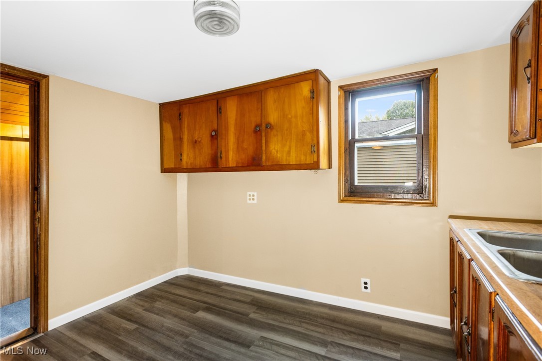 7529 State Line Burghill, OH 44404 - Photo 8 of 23 Washroom with dark wood-style flooring and baseboards