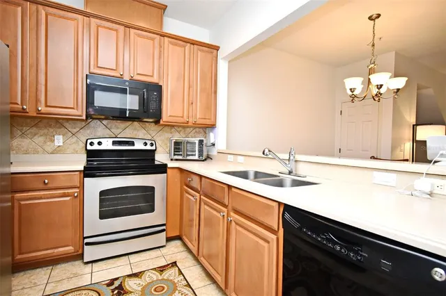 a kitchen with stainless steel appliances granite countertop a sink stove and microwave