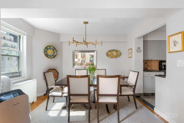 a view of a dining room with furniture and chandelier