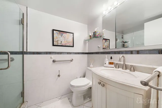 a bathroom with a toilet a sink and mirror