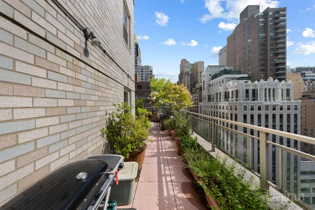 a view of a patio with table and chairs and potted plants
