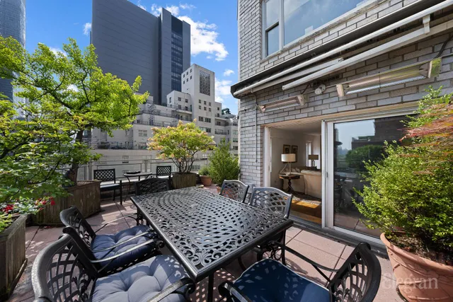 a view of a patio with table and chairs and potted plants