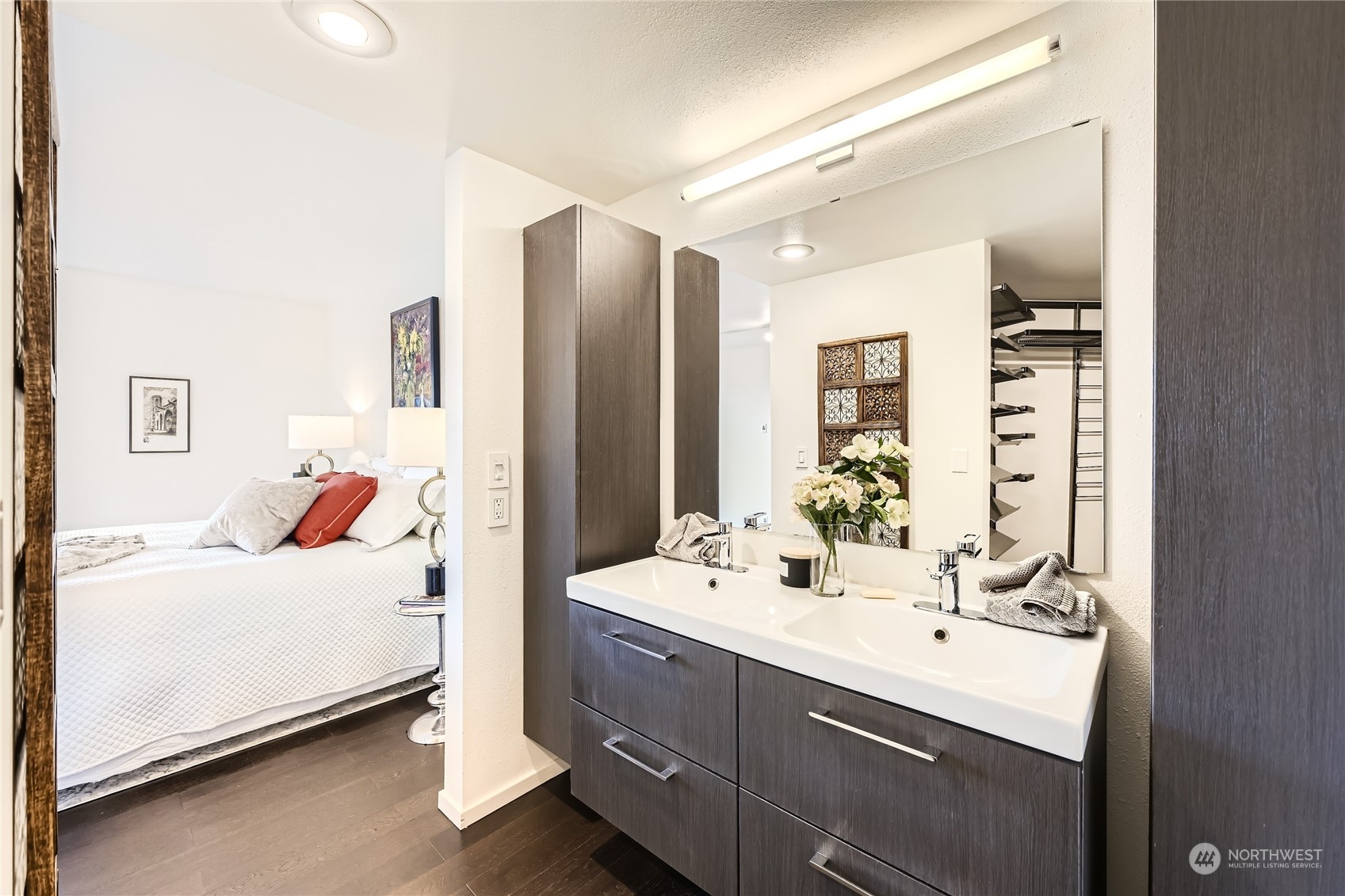 619 5th Avenue West, Unit 401 Seattle, WA 98119 - Photo 14 of 29 a en suite bathroom with a double vanity sink and mirror
