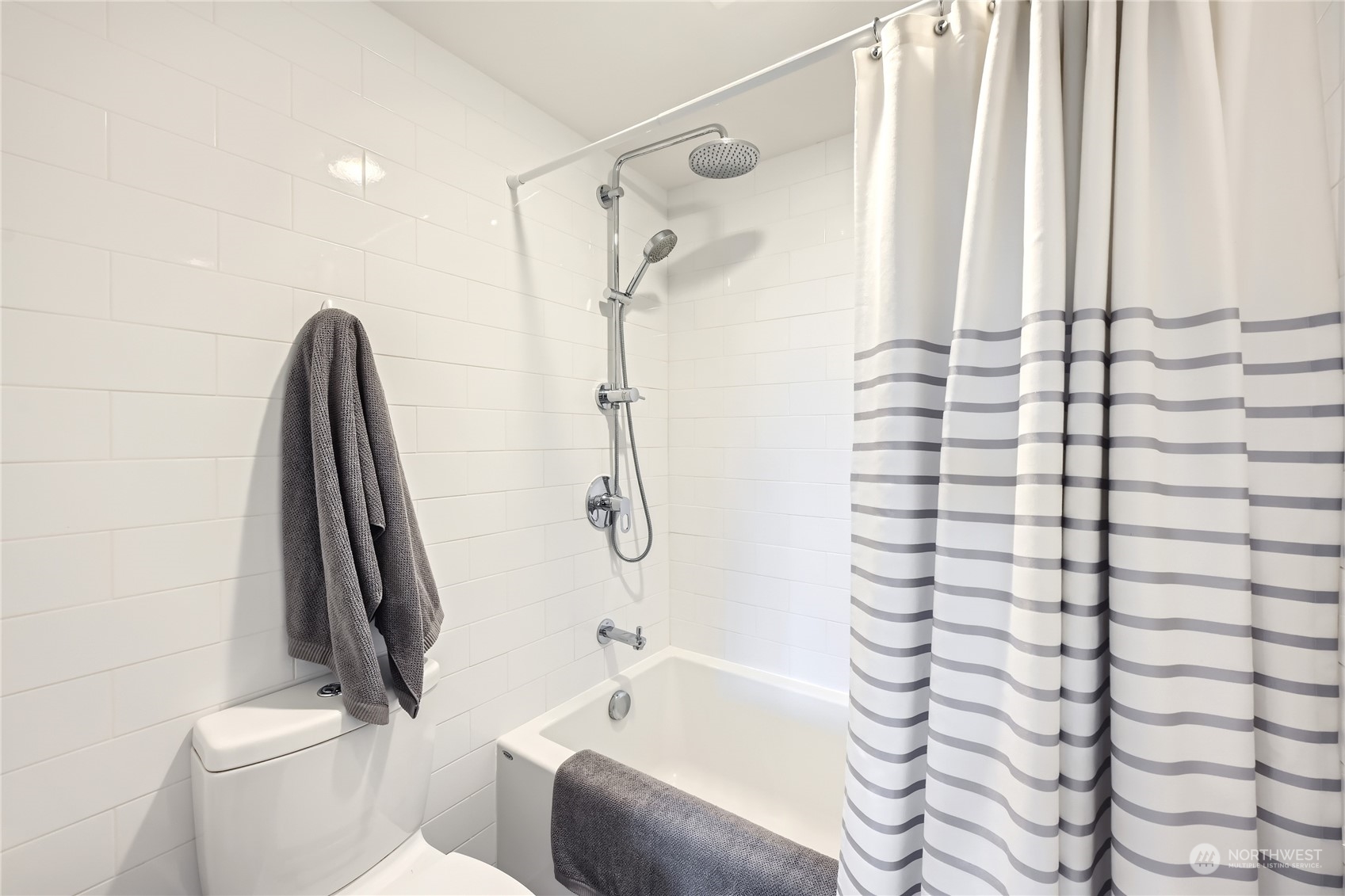 619 5th Avenue West, Unit 401 Seattle, WA 98119 - Photo 16 of 29 a bathroom with a shower curtain and a toilet
