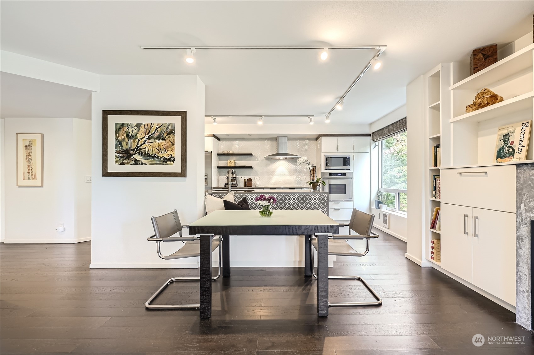 619 5th Avenue West, Unit 401 Seattle, WA 98119 - Photo 6 of 29 a view of a workspace with furniture window and wooden floor