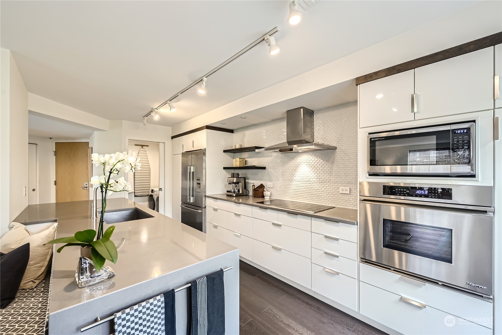 619 5th Avenue West, Unit 401 Seattle, WA 98119 - Photo 9 of 29 a kitchen with stainless steel appliances granite countertop a stove refrigerator and cabinets