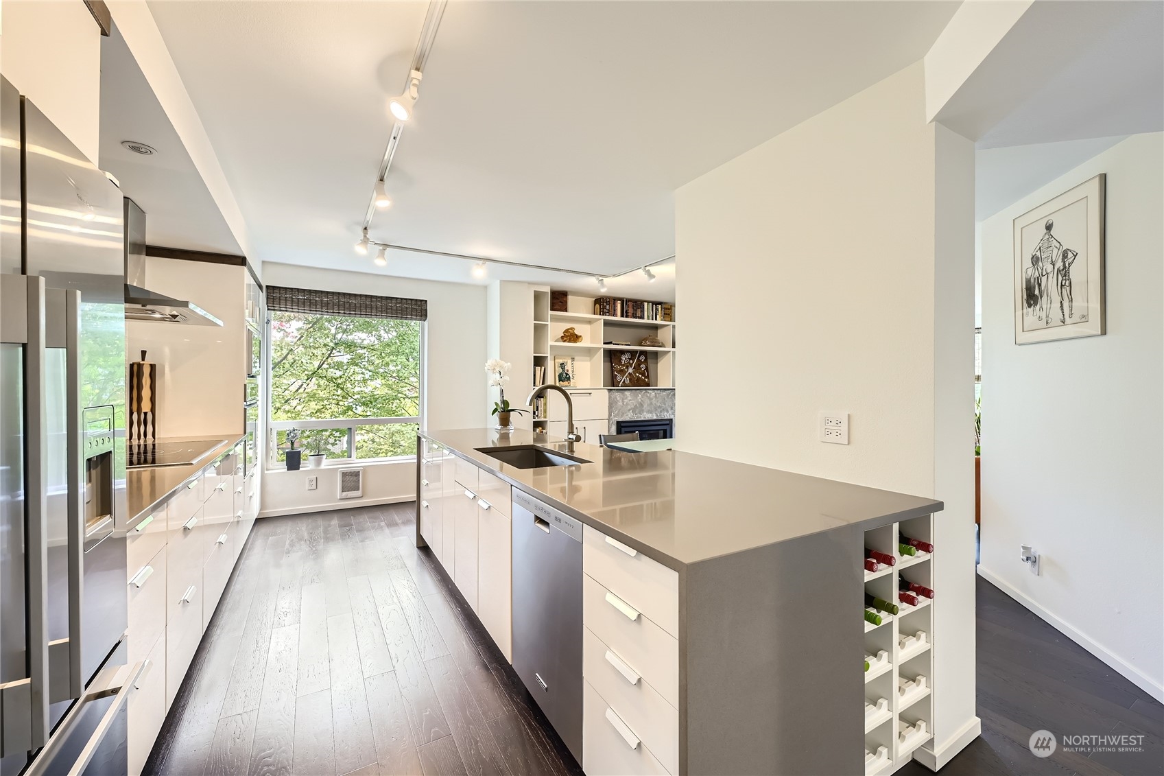 619 5th Avenue West, Unit 401 Seattle, WA 98119 - Photo 10 of 29 a large kitchen with kitchen island a large window a sink and stainless steel appliances