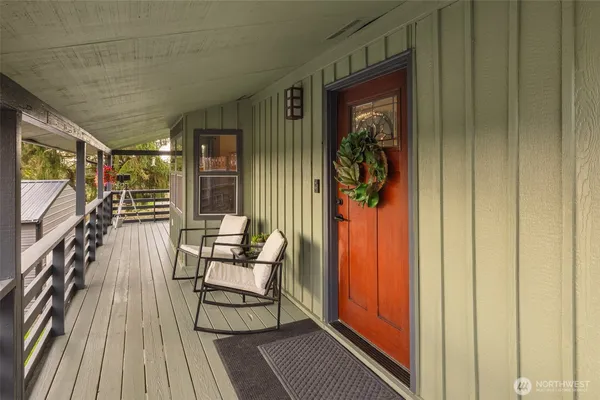 a balcony with chairs and wooden floor