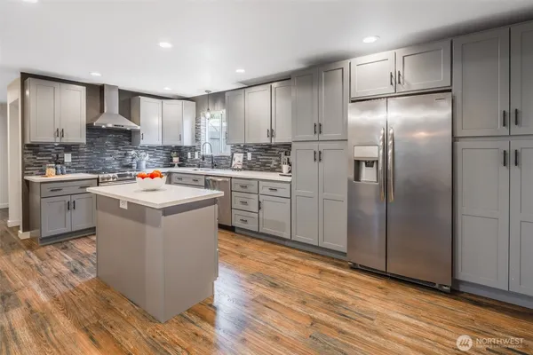 a kitchen with a sink cabinets and stainless steel appliances