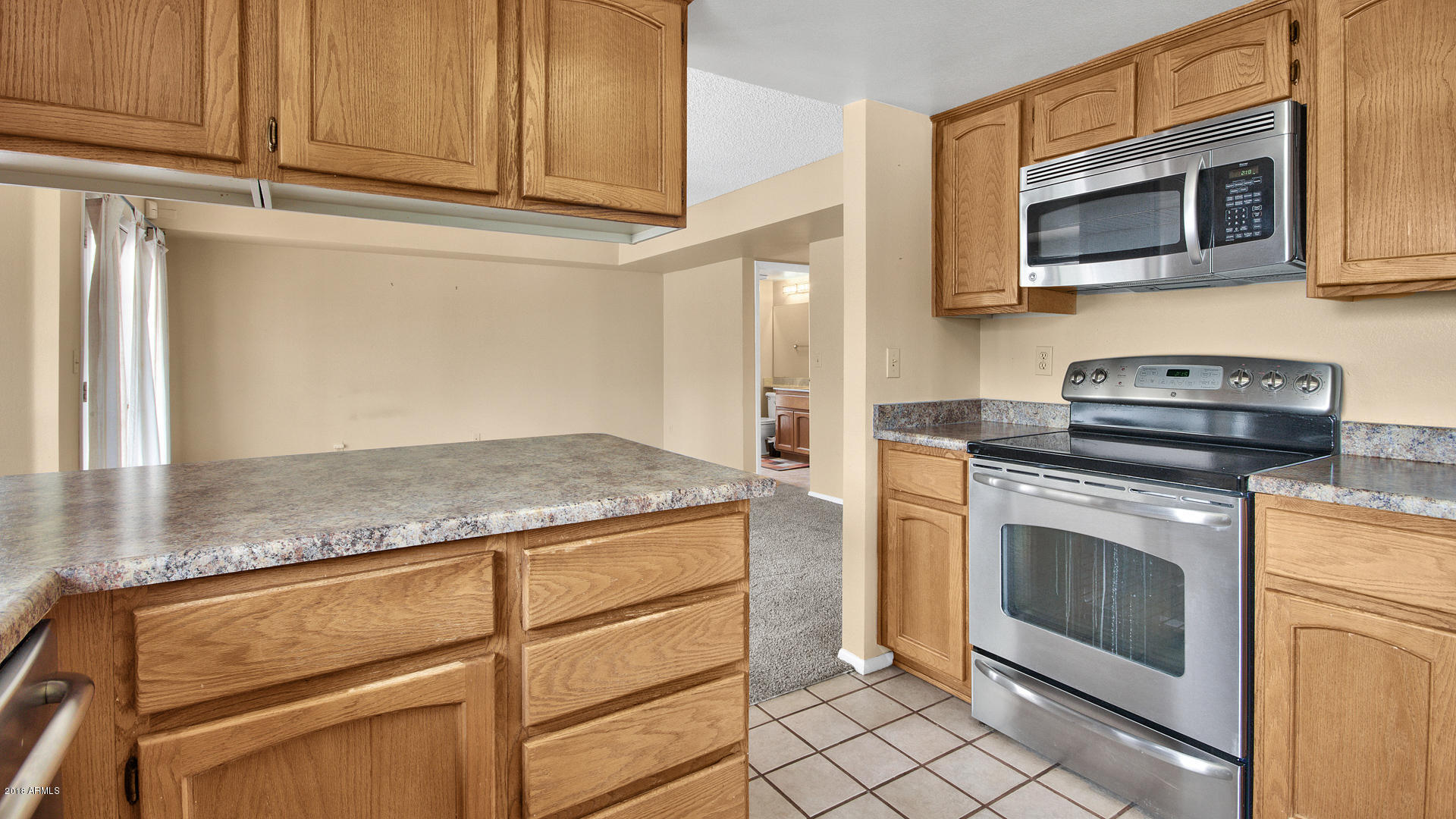 301 West Grandview Road Phoenix, AZ 85023 - Photo 4 of 15 a kitchen with granite countertop cabinets stainless steel appliances and a counter space