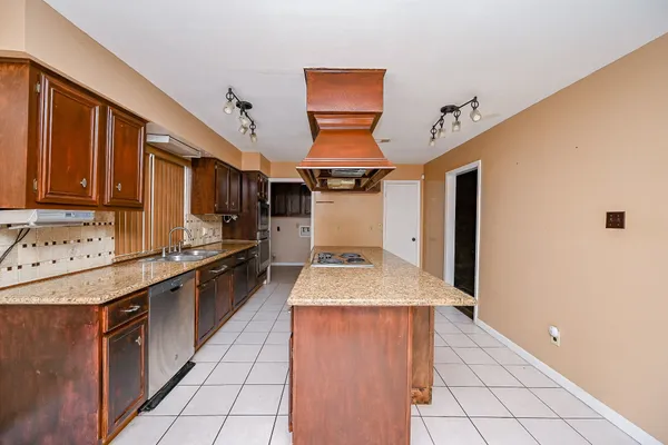 a kitchen with stainless steel appliances granite countertop a sink stove and cabinets