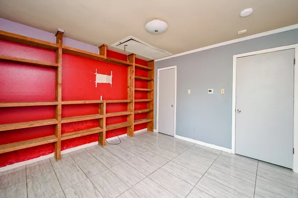 a view of empty room with wooden floor and windows