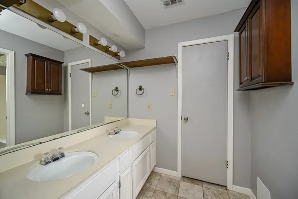 a bathroom with a double vanity sink and mirror