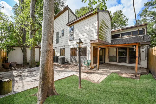 a view of a house with backyard porch and sitting area