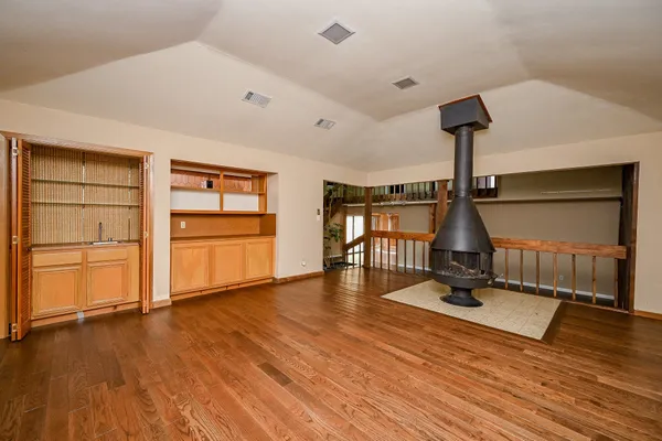 a view of a room with wooden floor and windows