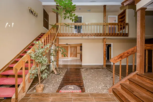 a view of a balcony with wooden floor and stairs