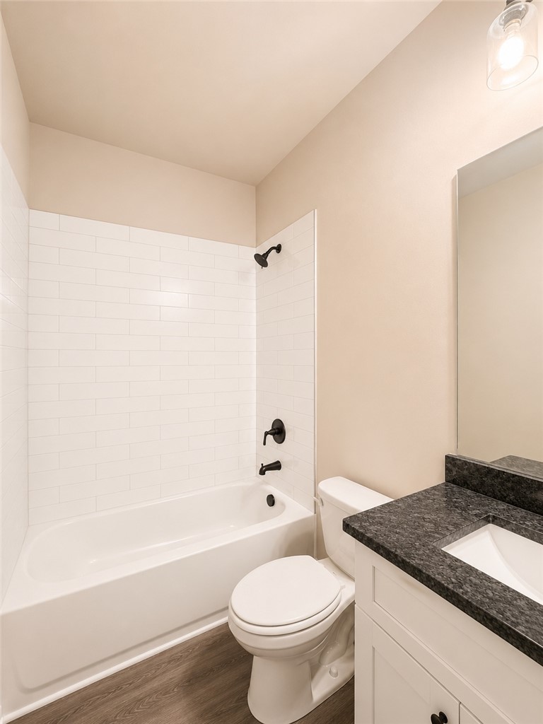 328 Point Road Westminster, SC 29693 - Photo 19 of 24 A well-lit primary bathroom featuring a tub and shower combination with dark bronze fixtures.
