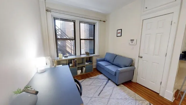 a living room with furniture and a floor to ceiling window