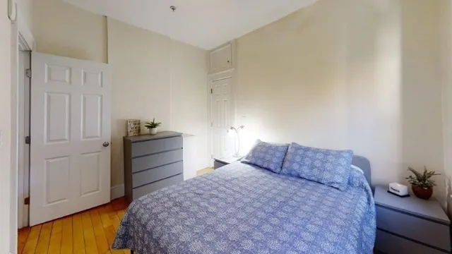 a bedroom with a bed and cabinets