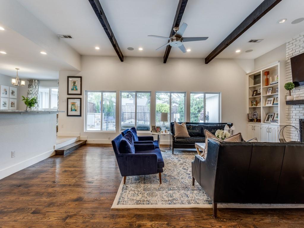 a living room with fireplace furniture and a large window