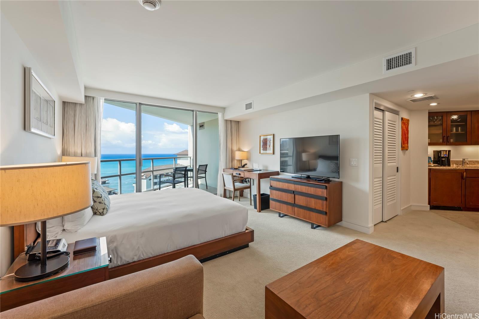 a bedroom with furniture and a flat screen tv