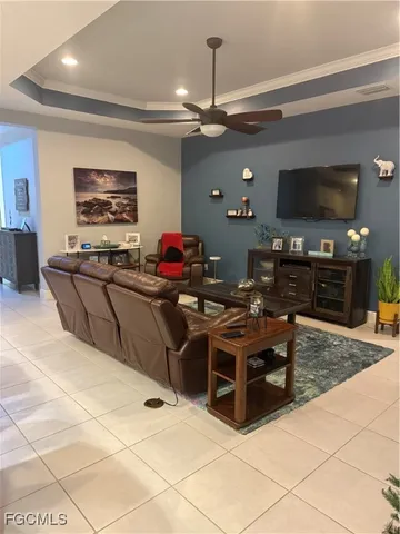 a living room with furniture a flat screen tv and a dining table
