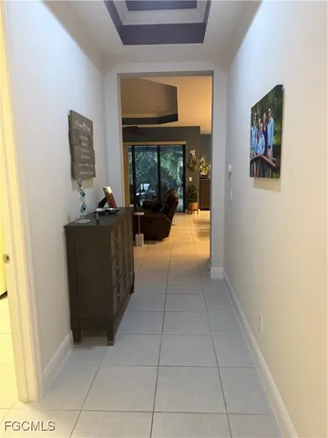 a view of a hallway with workspace and windows