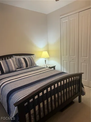 a bedroom with a bed and chair