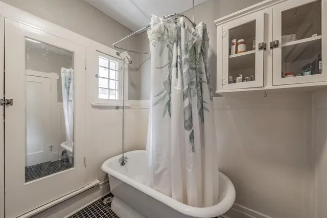 a bathroom with a bathtub and shower