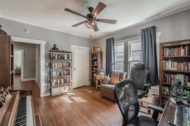 a living room with furniture and a book shelf