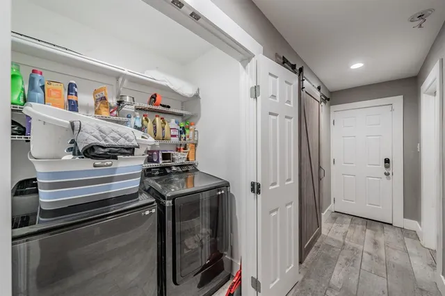 a view of a hallway with washer and dryer