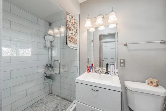 a bathroom with a sink mirror and toilet
