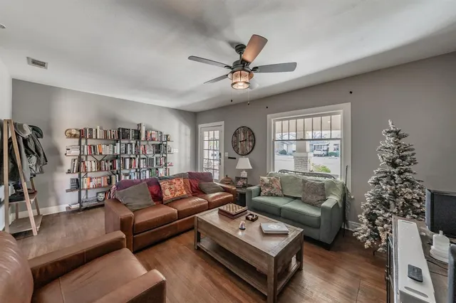 a living room with furniture a rug and a window