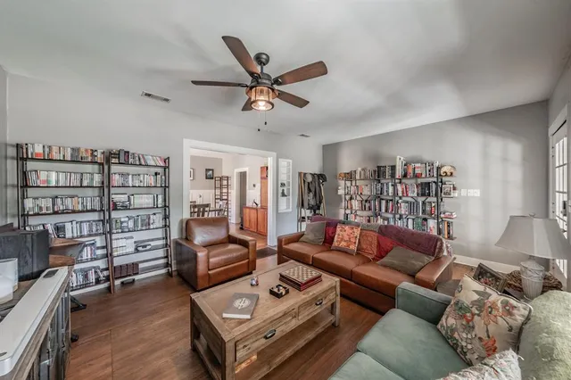 a living room with furniture and a book shelf