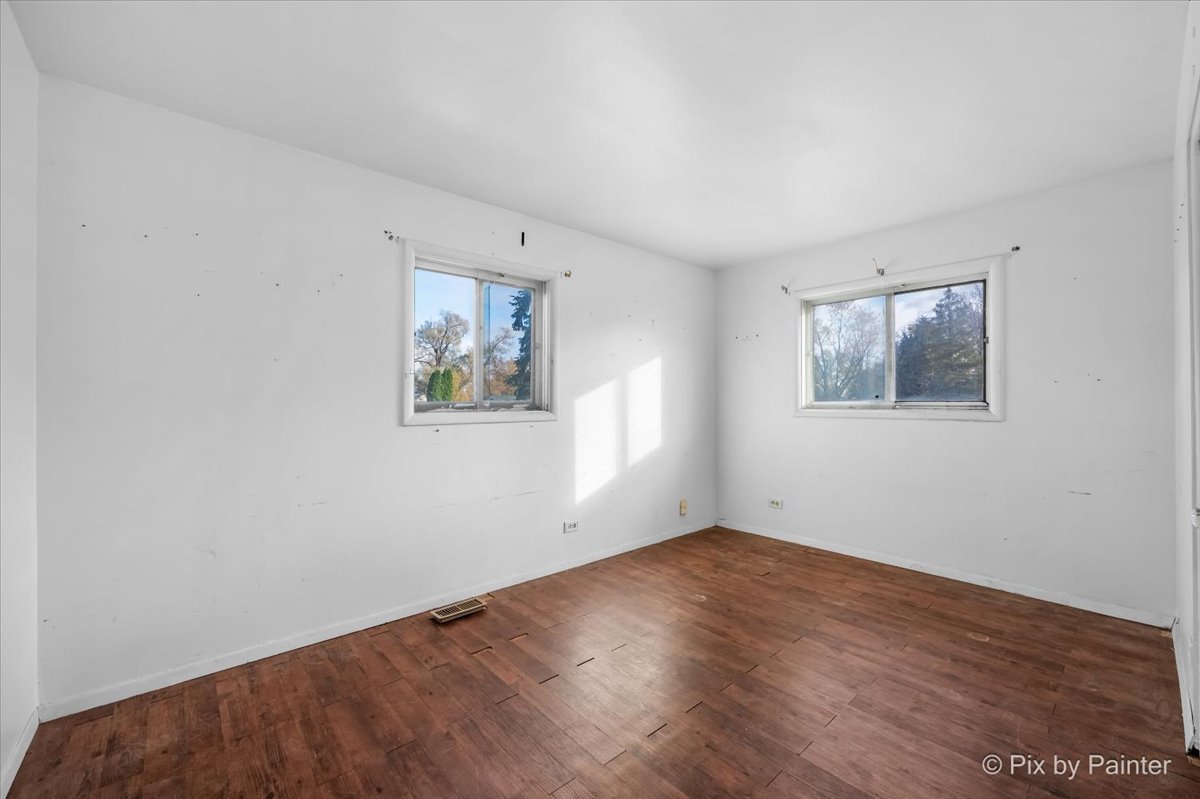 500 Colgate Court Hoffman Estates, IL 60169 - Photo 16 of 28 an empty room with wooden floor and window